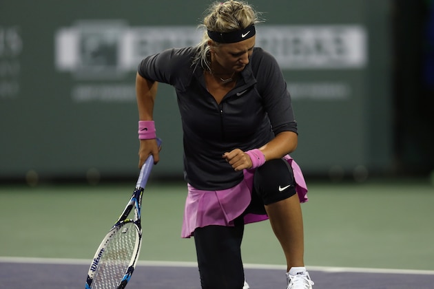 INDIAN WELLS, CA - MARCH 07:  Victoria Azarenka of Belarus is slow to get up after returning a shot to Lauren Davis during the BNP Paribas Open at Indian Wells Tennis Garden on March 7, 2014 in Indian Wells, California.  (Photo by Jeff Gross/Getty Images)