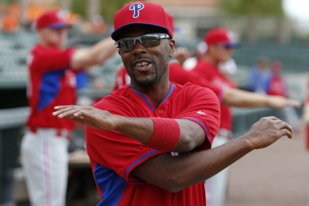 Philadelphia Phillies' Jimmy Rollins warms up before before an exhibition spring training baseball game against the Baltimore Orioles in Sarasota, Fla., Friday, March 7, 2014. (AP Photo/Gene J. Puskar)
