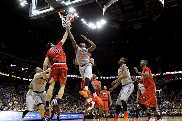 KANSAS CITY, MO - MARCH 12:  Marcus Smart #33 of the Oklahoma State Cowboys battles Dejan Kravic #11 of the Texas Tech Red Raiders for a rebound during the Big 12 Basketball Tournament first round game at the Sprint Center on March 12, 2014 in Kansas City, Missouri.  (Photo by Jamie Squire/Getty Images)