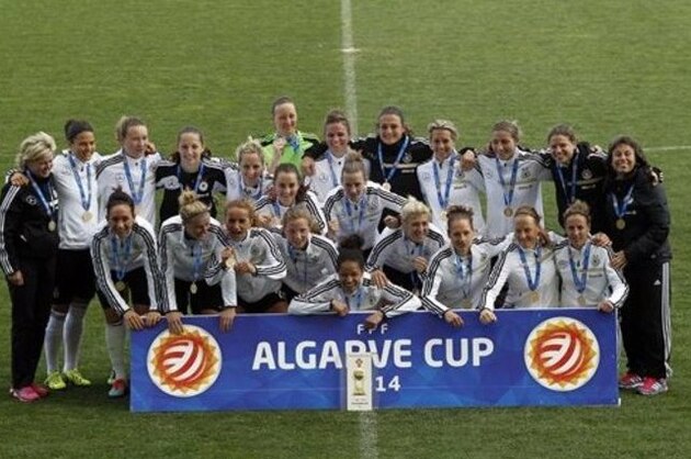 Germany's team pose for the media with their trophy after winning the women's soccer Algarve Cup at the Algarve stadium, outside Faro, southern Portugal, Wednesday, March 12, 2014. (AP Photo/Francisco Seco)