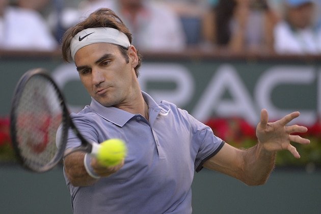 Roger Federer, of Switzerland, returns a shot against Tommy Haas, of Germany, during a match at the BNP Paribas Open tennis tournament, Wednesday, March 12, 2014, in Indian Wells, Calif. (AP Photo/Mark J. Terrill)
