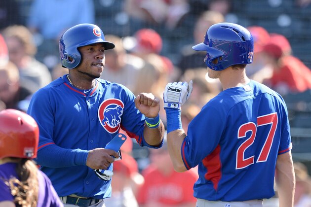 TEMPE, AZ - MARCH 07:  Luis Valbuena #24 and teammate Josh Vitters #27 of the Chicago Cubs celebrate scoring a seventh inning run against the Anaheim Angels at Tempe Diablo Stadium on March 7, 2014 in Tempe, Arizona.  (Photo by Norm Hall/Getty Images)