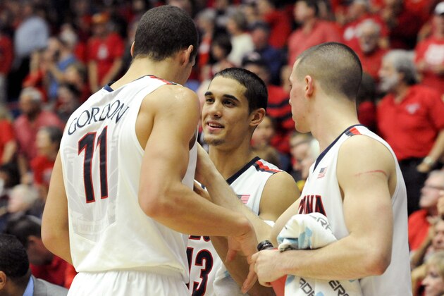 Feb 26, 2014; Tucson, AZ, USA; Arizona Wildcats guard Nick Johnson (13) talks to forward Aaron Gordon (11) on the bench during the second half against the California Golden Bears at McKale Center. Arizona won 87-59. Mandatory Credit: Casey Sapio-USA TODAY Sports