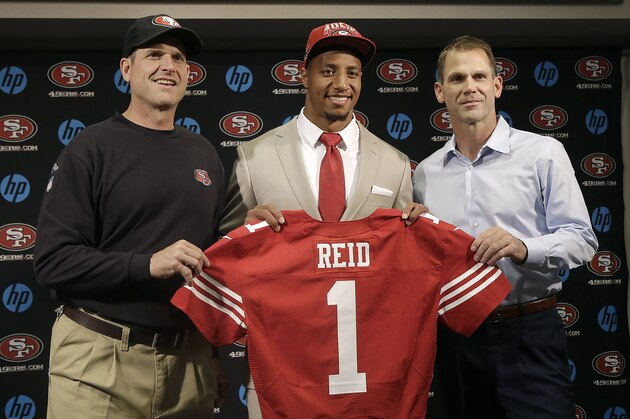 Safety Eric Reid, the first-round draft pick of the San Francisco 49ers, center, holds up a jersey with head coach Jim Harbaugh, left, and general manager Trent Baalke during a news conference at the team's training facility in Santa Clara, Calif., Friday, April 26, 2013. (AP Photo/Jeff Chiu) Safety Eric Reid, the first-round draft pick of the San Francisco 49ers, center, holds up a jersey with head coach Jim Harbaugh, left, and general manager Trent Baalke during a news conference at the team's training facility in Santa Clara, Calif., Friday, April 26, 2013. (AP Photo/Jeff Chiu)