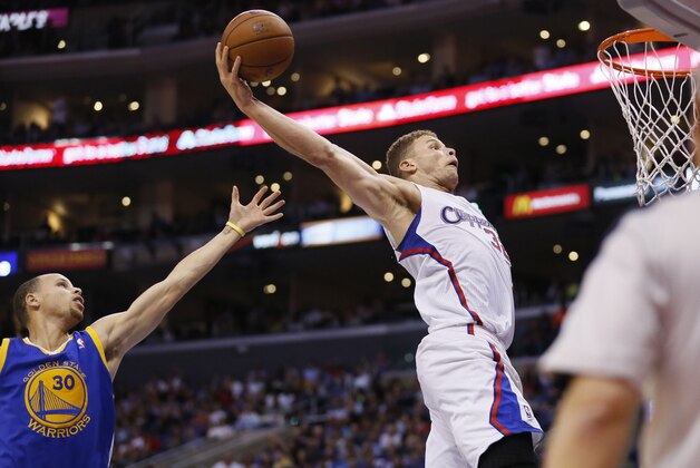 Los Angeles Clippers' Blake Griffin dunks the ball on a rebound in front of Golden State Warriors Stephen Curry, left, during the second half of an NBA basketball game in Los Angeles, Wednesday, March 12, 2014. The Clippers won 111-98. (AP Photo/Danny Moloshok)