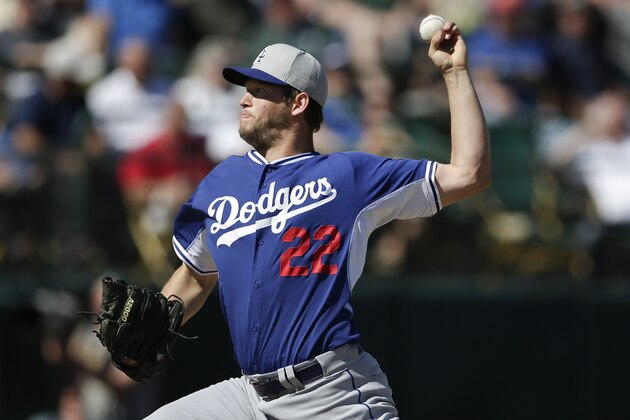 Los Angeles Dodgers pitcher Clayton Kershaw pitches to an Oakland Athletics batter during the first inning of a spring training baseball game Monday, March 3, 2014, in Phoenix. (AP Photo/Gregory Bull)