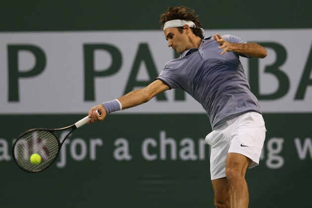INDIAN WELLS, CA - MARCH 12:  Roger Federer of Switzerland hits a return to Tommy Haas of Germany during the BNP Paribas Open at Indian Wells Tennis Garden on March 12, 2014 in Indian Wells, California.  (Photo by Stephen Dunn/Getty Images)