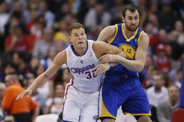 Los Angeles Clippers' Blake Griffin, left, fights for position with Golden State Warriors' Andrew Bogut during the first half of an NBA basketball game in Los Angeles, Wednesday, March 12, 2014. (AP Photo/Danny Moloshok)