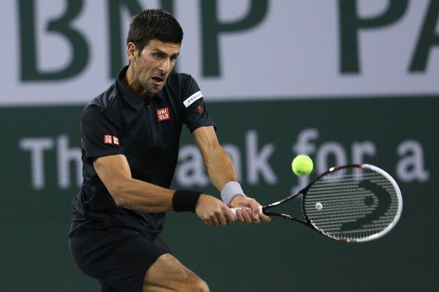 INDIAN WELLS, CA - MARCH 12:  Novak Djokovic of Serbia hits a return to Marin Cilic of Croatia during the BNP Paribas Open at Indian Wells Tennis Garden on March 12, 2014 in Indian Wells, California.  (Photo by Stephen Dunn/Getty Images)