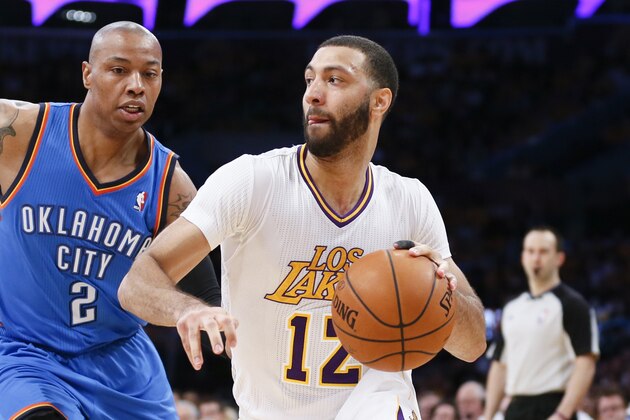 Los Angeles Lakers point guard Kendall Marshall dribbles around Oklahoma City Thunder small forward Caron Butler, center, and Oklahoma City Thunder shooting guard Jeremy Lamb during the second half of an NBA basketball game in Los Angeles, Sunday, March 9, 2014. The Lakers won 114-110. (AP Photo/Danny Moloshok)