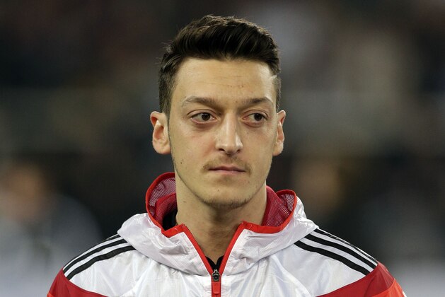 Germany's Mesut Ozil waits for the national anthems to begin during the international friendly soccer match between Germany and Chile in Stuttgart, Germany, Wednesday, March 5, 2014. (AP Photo/Matthias Schrader)