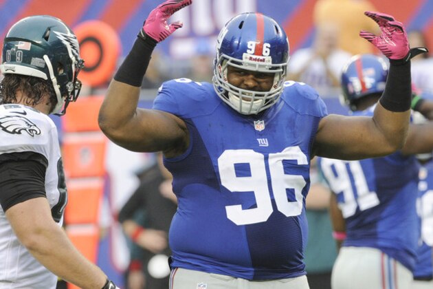 New York Giants' Johnathan Hankins (96) reacts as Philadelphia Eagles' Evan Mathis looks on during the second half of an NFL football game Sunday, Oct. 6, 2013, in East Rutherford, N.J.  (AP Photo/Bill Kostroun)