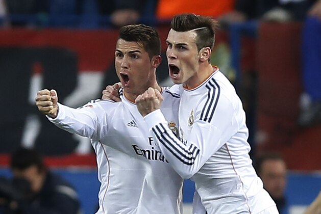 Real's Cristiano Ronaldo, left, celebrates his goal with teammate Gareth Bale, center, during a Spanish La Liga soccer match between Atletico de Madrid and Real Madrid at the Vicente Calderon stadium in Madrid, Spain, Sunday, March 2, 2014. (AP Photo/Andres Kudacki)