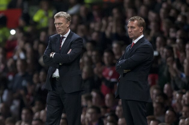 Manchester United's manager David Moyes, left, stands alongside Liverpool's manager Brendan Rodgers during their English League Cup soccer match at Old Trafford Stadium, Manchester, England, Wednesday Sept. 25, 2013. (AP Photo/Jon Super)