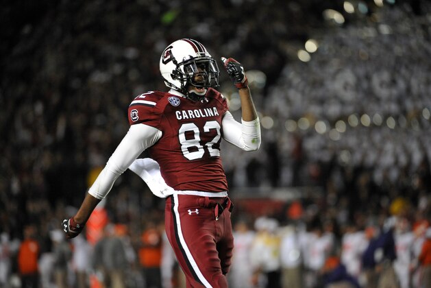 South Carolina wide receiver Kwinton Smith (82) celebrates his team's fumble recovery during the second half of an NCAA college football game against Clemson on Saturday, Nov. 30, 2013, in Columbia, S.C. South Carolina won 31-17. (AP Photo/Rainier Ehrhardt)