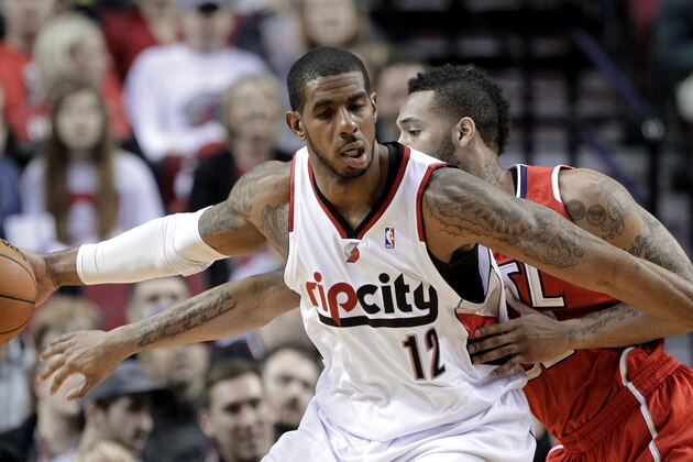 Atlanta Hawks forward Mike Scott, right, plays tight defense on Portland Trail Blazers forward LaMarcus Aldridge during the first half of an NBA basketball game in Portland, Ore., Wednesday, March 5, 2014. (AP Photo/Don Ryan)
