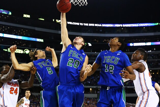 ARLINGTON, TX - MARCH 29: Chase Fieler #20 pulls down a rebound inbetween Christophe Varidel #5 and Eric McKnight #12 of the Florida Gulf Coast Eagles against the Florida Gators during the South Regional Semifinal round of the 2013 NCAA Men's Basketball Tournament at Dallas Cowboys Stadium on March 29, 2013 in Arlington, Texas. (Photo by Tom Pennington/Getty Images) ARLINGTON, TX - MARCH 29: Chase Fieler #20 pulls down a rebound inbetween Christophe Varidel #5 and Eric McKnight #12 of the Florida Gulf Coast Eagles against the Florida Gators during the South Regional Semifinal round of the 2013 NCAA Men's Basketball Tournament at Dallas Cowboys Stadium on March 29, 2013 in Arlington, Texas. (Photo by Tom Pennington/Getty Images)