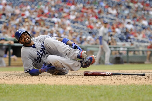 Los Angeles Dodgers' fielder Matt Kemp grimaces as he was out at home and hurt on the play against the Washington Nationals during the ninth inning of a baseball game, Sunday, July 21, 2013, in Washington. The Dodgers won 9-2. (AP Photo/Nick Wass)