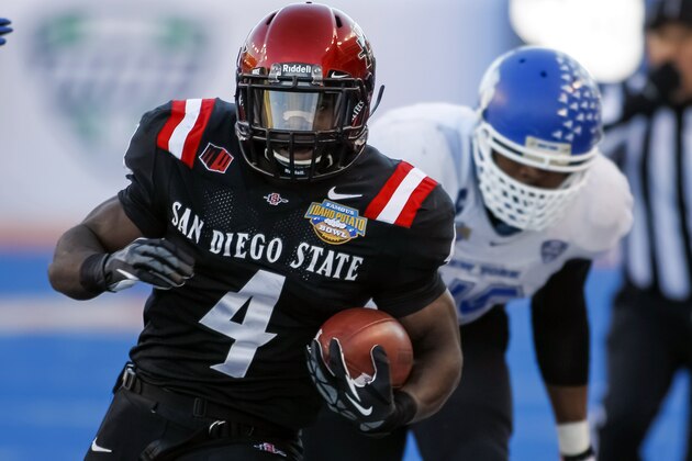 San Diego State running back Adam Muema (4) runs the ball past Buffalo linebacker Khalil Mack during the first half of the Famous Idaho Potato Bowl NCAA college football game in Boise, Idaho, on Saturday, Dec. 21, 2013. San Diego State won 49-24. (AP Photo/Otto Kitsinger)