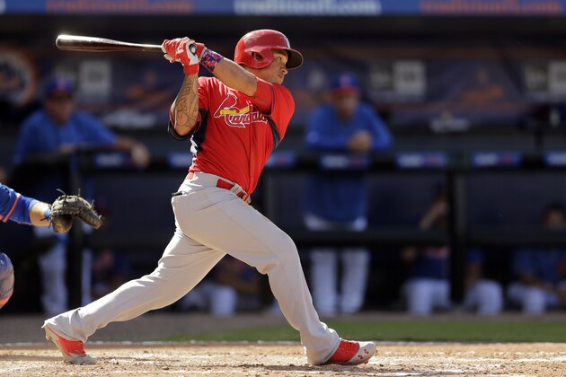 St. Louis Cardinals' Kolten Wong hits an RBI-single during the sixth inning of an exhibition spring training baseball game against the New York Mets Friday, March 7, 2014, in Port St. Lucie, Fla. (AP Photo/Jeff Roberson)