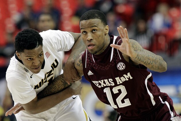 Missouri guard Wes Clark (1) and Texas A&M guard Fabyon Harris (12) vie for a loose ball during the first half of an NCAA college basketball game in the second round of the Southeastern Conference men's tournament, Thursday, March 13, 2014, in Atlanta. (AP Photo/Steve Helber)