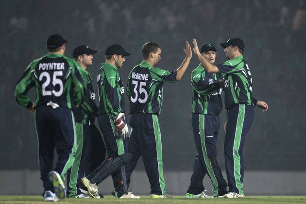 Ireland’s Andy McBrine, center, celebrates with teammates the dismissal of Nepal’s Sharad Vesawkar during a warm-up cricket match ahead of the Twenty20 World Cup Cricket in Fatullah, near Dhaka, Bangladesh, Wednesday, March 12, 2014. (AP Photo/A.M. Ahad)