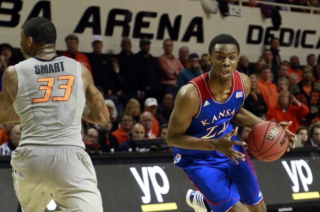 Mar 1, 2014; Stillwater, OK, USA;  Kansas Jayhawks guard Andrew Wiggins (22) drives against Oklahoma State Cowboys guard Marcus Smart (33) during the second half at Gallagher-Iba Arena. Oklahoma State beat Kansas 72-65. Mandatory Credit: Tim Heitman-USA TODAY Sports