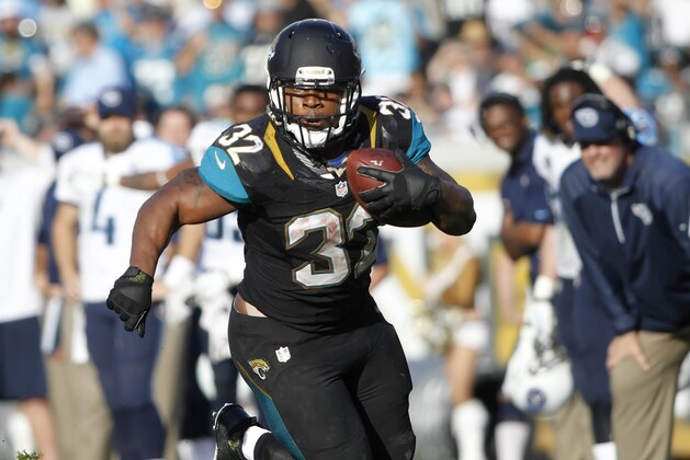 Dec 22, 2013; Jacksonville, FL, USA; Jacksonville Jaguars running back Maurice Jones-Drew (32) runs with the ball as Tennessee Titans defends during the second half at EverBank Field. Tennessee Titans defeated the Jacksonville Jaguars 20-16.  Mandatory Credit: Kim Klement-USA TODAY Sports