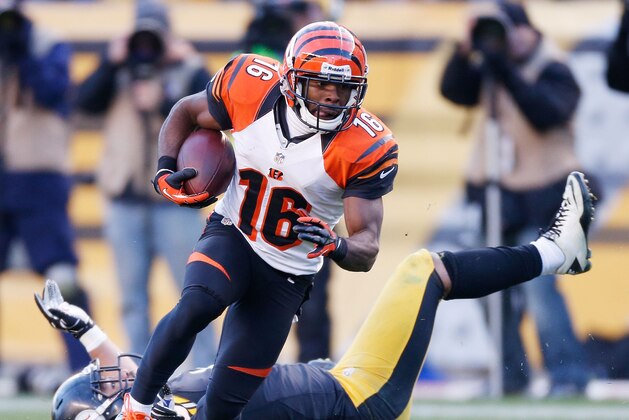 PITTSBURGH, PA - DECEMBER 23:  Andrew Hawkins #16 of the Cincinnati Bengals looks for extra yards in the fourth quarter after escaping the tackle of Troy Polamalu #43 of the Pittsburgh Steelers at Heinz Field on December 23, 2012 in Pittsburgh, Pennsylvania. Cincinnati won the game 13-10. (Photo by Gregory Shamus/Getty Images)