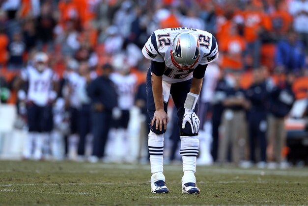 January 19, 2014; Denver, CO, USA; New England Patriots quarterback Tom Brady (12) reacts against the Denver Broncos in the second half of the 2013 AFC Championship football game at Sports Authority Field at Mile High. Mandatory Credit: Mark J. Rebilas-USA TODAY Sports