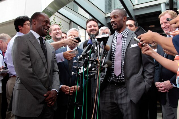 WASHINGTON, DC - JULY 25:  DeMaurice Smith (L) executive director of the National Football League Players' Association laughs at a comment made by Baltimore Ravens cornerback Domonique Foxworth (C) during a news conference July 25, 2011 in Washington, DC.  The NFL players and owners are set to agree on a labor deal and end the current lockout.  (Photo by Rob Carr/Getty Images)