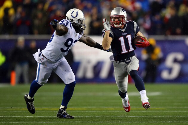 FOXBORO, MA - JANUARY 11:  Julian Edelman #11 of the New England Patriots runs the ball against Erik Walden #93 of the Indianapolis Colts in the first quarter during the AFC Divisional Playoff game at Gillette Stadium on January 11, 2014 in Foxboro, Massachusetts.  (Photo by Al Bello/Getty Images)