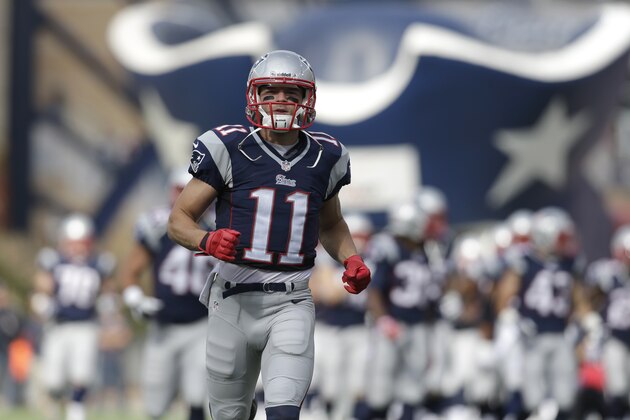 New England Patriots wide receiver Julian Edelman (11), center, runs onto the field with his team before an NFL football game against the Miami Dolphins Sunday, Oct. 27, 2013, in Foxborough, Mass. (AP Photo/Steven Senne)