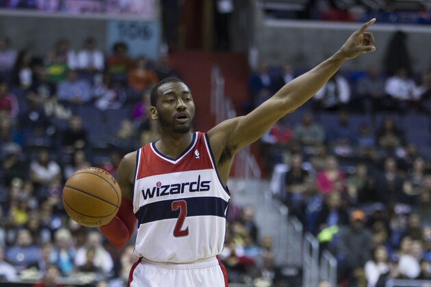 Washington Wizards point guard John Wall (2) brings the ball up the court during the first half of an NBA basketball game on Wednesday, March 5, 2014, in Washington. (AP Photo/ Evan Vucci)