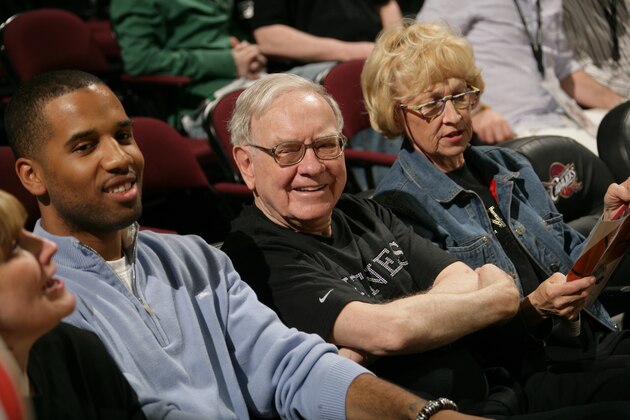 CLEVELAND - MARCH 25:  Philanthropist Warren Buffet (C) wears a LeBron James Witness tee-shirt as he cheers for the Cleveland Cavaliers during a game against the Denver Nuggets  March 25, 2007 at The Quicken Loans Arena in Cleveland, Ohio. NOTE TO USER: User expressly acknowledges and agrees that, by downloading and/or using this Photograph, user is consenting to the terms and conditions of the Getty Images License Agreement. Mandatory Copyright Notice: Copyright 2007 NBAE (Photo by David Liam Kyle/NBAE via Getty Images)