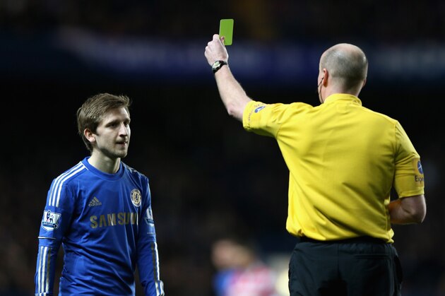 LONDON, ENGLAND - JANUARY 02:  Marko Marin of Chelsea is shown a yellow card by referee Lee Mason after a strong tackle on Stephane Mbia of Queens Park Rangers during the Barclays Premier League match between Chelsea and Queens Park Rangers at Stamford Bridge on January 2, 2013 in London, England.  (Photo by Ian Walton/Getty Images)