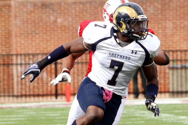 Shepherd University's Howard Jones (7) works his way through the block of Jose Urrutia (60) Saturday against the Cavaliers of UVa Wise. Saturday  Oct 12, 2013 Wise, Va (AP Photo/Larry N. Souders)