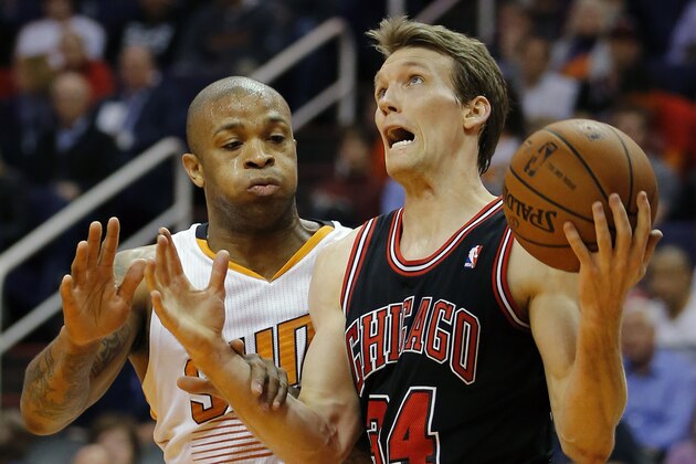 Chicago Bulls' Mike Dunleavy (34) drives past Phoenix Suns' P.J. Tucker during the first half of an NBA basketball game, Tuesday, Feb. 4, 2014, in Phoenix. (AP Photo/Matt York)