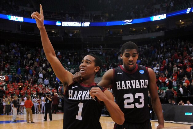 Mar 21, 2013; Salt Lake City, UT, USA; Harvard Crimson guard Siyani Chambers (1) celebrates with guard/forward Wesley Saunders (23) after the game against the New Mexico Lobos during the second round of the 2013 NCAA tournament at EnergySolutions Arena. Harvard won the game 68-62. Mandatory Credit: Steve Dykes-USA TODAY Sports