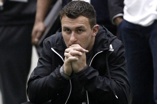 Texas A&M quarterback Johnny Manziel watches the Texas A&M Pro Day held at the McFerrin Athletic Center, Wednesday, March 5, 2014, in College Station, Texas. Manziel did not compete in the Pro Day.  (AP Photo/Patric Schneider)