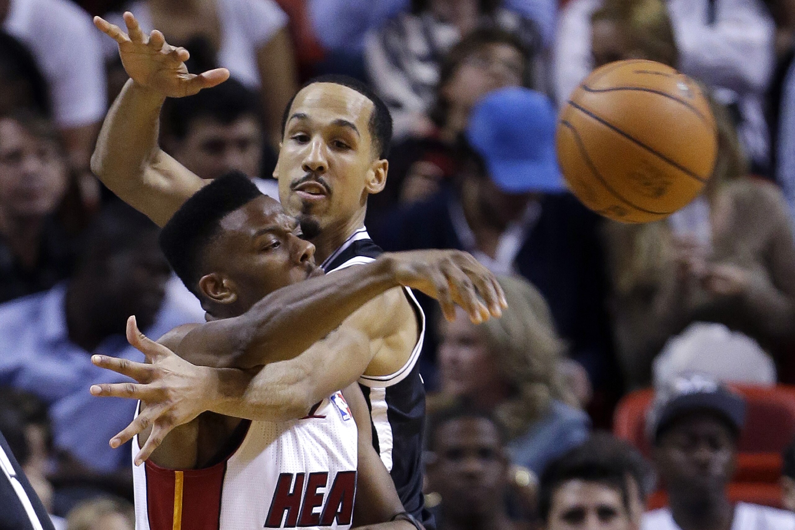 Miami Heat guard Norris Cole (30) passes past Brooklyn Nets guard Shaun Livingston, rear, during the second half of an NBA basketball game, Wednesday, March 12, 2014 in Miami. The Nets defeated the Heat 96-95. (AP Photo/Wilfredo Lee)