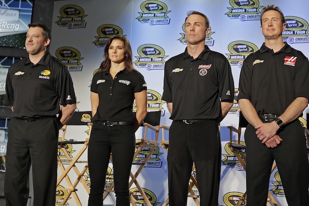 Drivers from Stewart-Haas racing, from left, Tony Stewart, Danica Patrick, Kevin Harvick and Kurt Busch, pose for a photo during a news conference at the NASCAR Sprint Cup auto racing Media Tour in Charlotte, N.C., Monday, Jan. 27, 2014. (AP Photo/Chuck Burton)