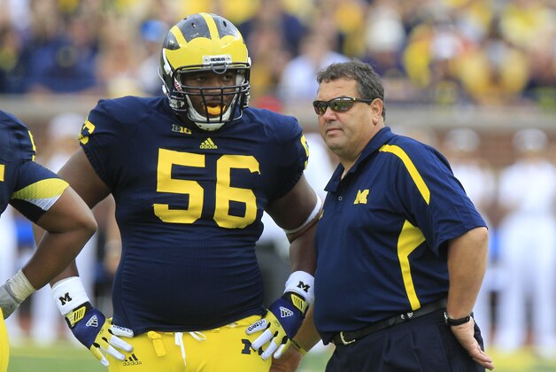 Michigan head coach Brady Hoke talks with defensive tackle Ondre Pipkins (56)during the second half of an NCAA college football game against Air Force at Michigan Stadium in Ann Arbor, Mich., Saturday, Sept. 8, 2012. (AP Photo/Carlos Osorio)