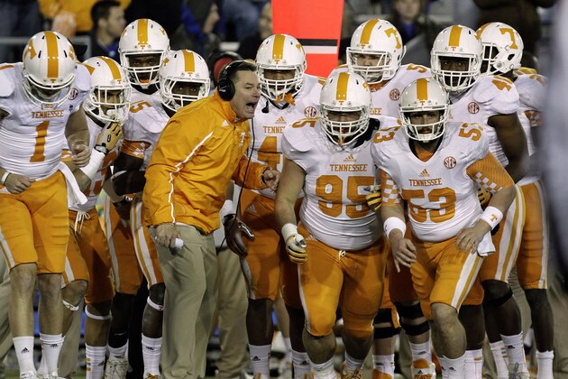 Tennessee coach Butch Jones, center, sends his team ontp the field in the fourth quarter against Kentucky in an NCAA college football game in Lexington, Ky., Saturday, Nov. 30, 2013. Tennessee won 27-14. (AP Photo/Garry Jones)