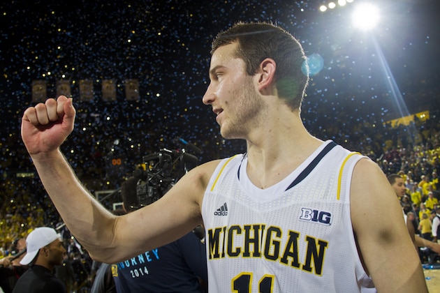 Michigan guard Nik Stauskas (11) cheers after an NCAA college basketball game against Indiana in Ann Arbor, Mich., Saturday, March 8, 2014. Michigan won 84-80. (AP Photo/Tony Ding)