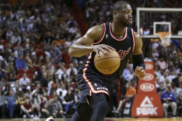Miami Heat shooting guard Dwyane Wade (3) drives against the Orlando Magic during an NBA basketball game in Miami, Saturday, March 1, 2014. (AP Photo/Alan Diaz)
