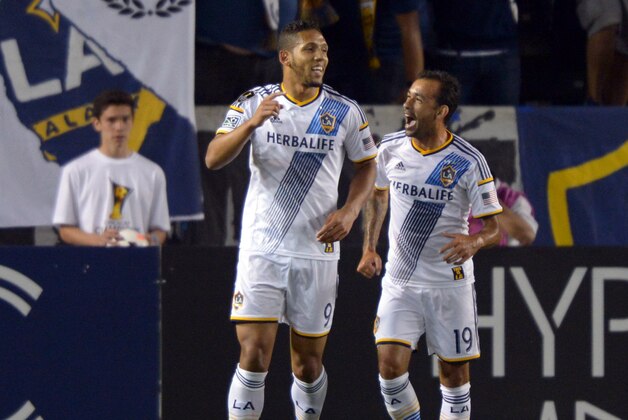 Mar 12, 2014; Carson, CA, USA; Los Angeles Galaxy forward Samuel (9) celebrates with midfielder Juninho (19) after scoring a goal in the first half in Champions League match against Club Tijuana at StubHub Center. Mandatory Credit: Kirby Lee-USA TODAY Sports