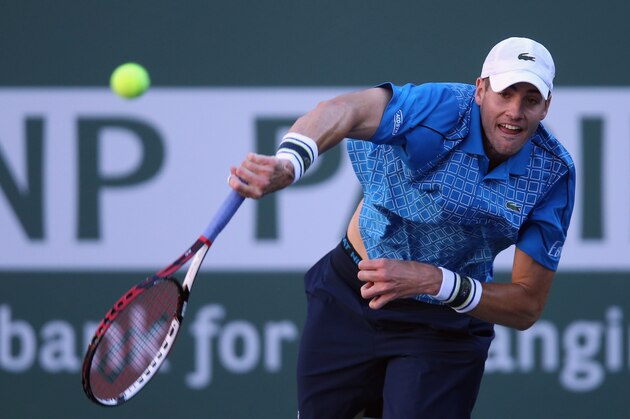INDIAN WELLS, CA - MARCH 12:  John Isner serves to Fernando Verdasco of Spain during the BNP Paribas Open at Indian Wells Tennis Garden on March 12, 2014 in Indian Wells, California.  (Photo by Jeff Gross/Getty Images)