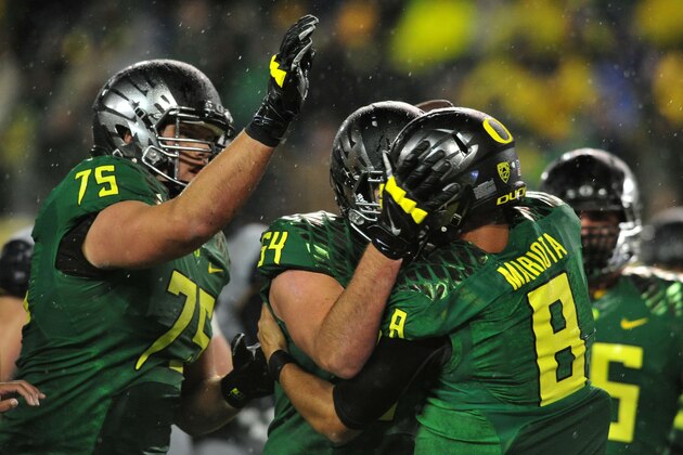 EUGENE, OR. - SEPTEMBER 28: Quarterback Marcus Mariota #8 of the Oregon Ducks celebrates with the teammates including offensive linesman Jake Fisher #75 and offensive linesman Tyler Johnstone #64 of the Oregon Ducks after scoring a touchdown during the second quarter of the game against the California Golden Bears at Autzen Stadium on September 28, 2013 in Eugene, Oregon. (Photo by Steve Dykes/Getty Images)