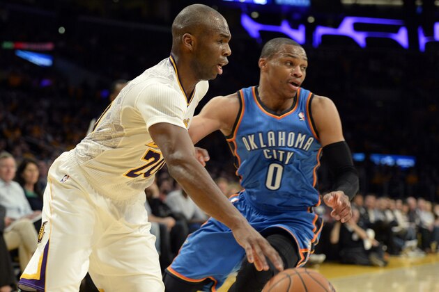 Mar 9, 2014; Los Angeles, CA, USA; Los Angeles Lakers shooting guard Jodie Meeks (20) drives against Oklahoma City Thunder point guard Russell Westbrook (0) during the second half at Staples Center. Mandatory Credit: Richard Mackson-USA TODAY Sports
